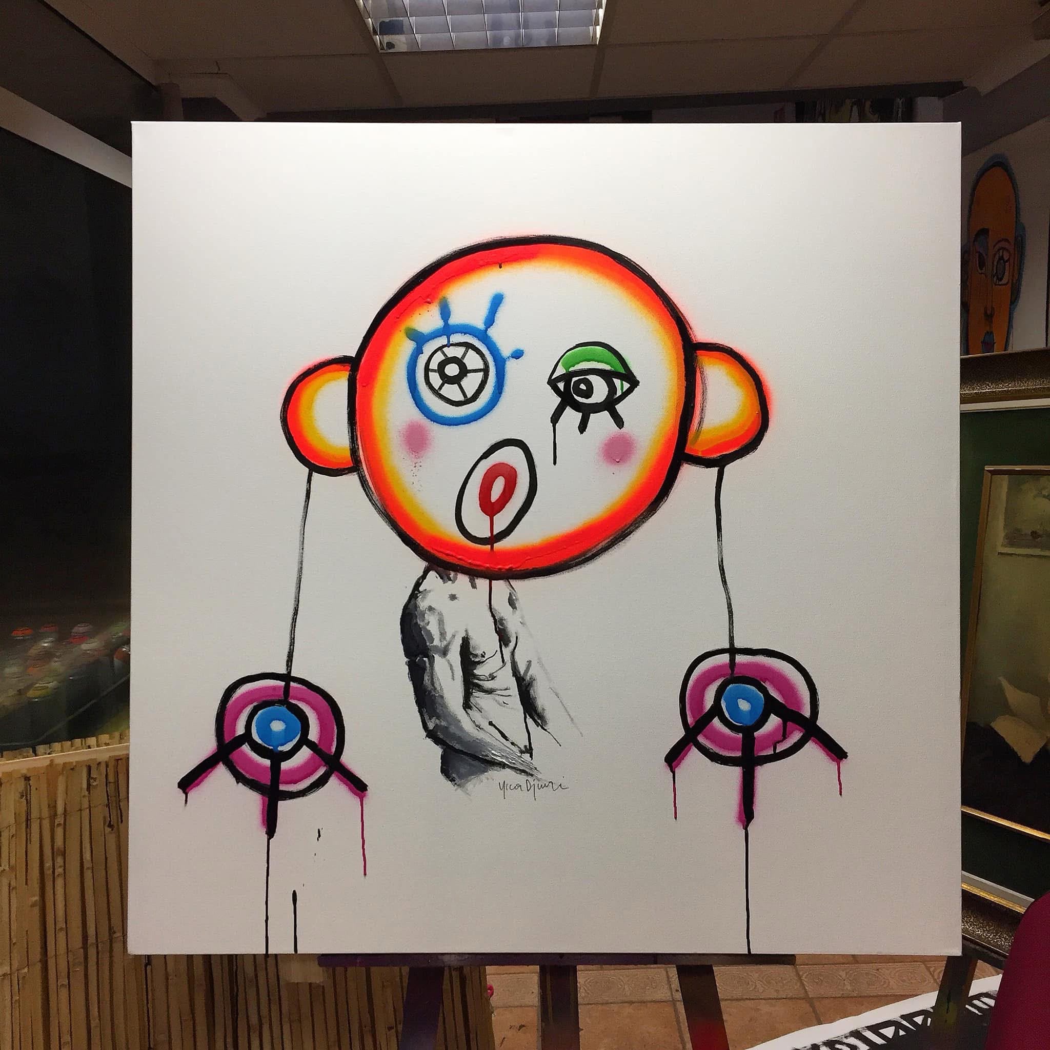 Yica Djuric bold character painting — neon concentric circle head with eye motifs on white canvas